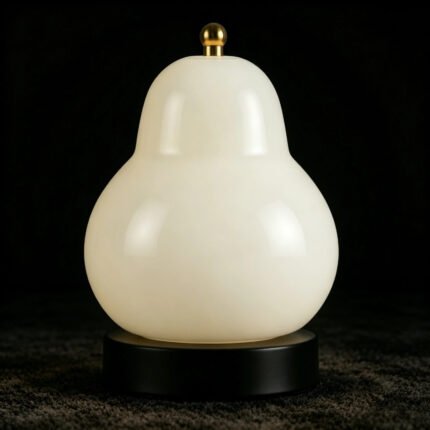 Cream yellow pear lamp off on dark background with brass finial